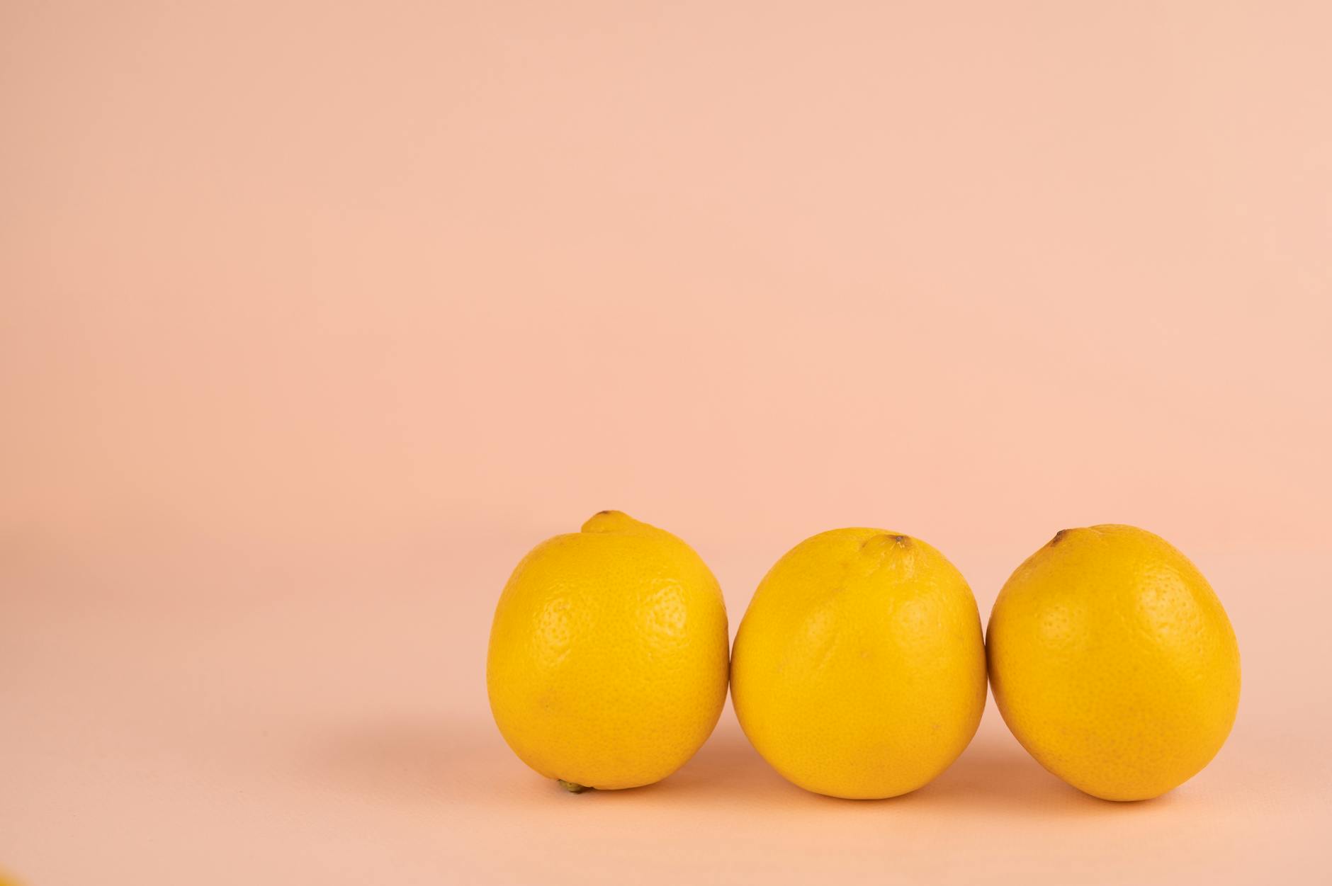 Bright ripe lemons with pleasant aroma on a pastel background, symbolizing renewal and refreshed sensation